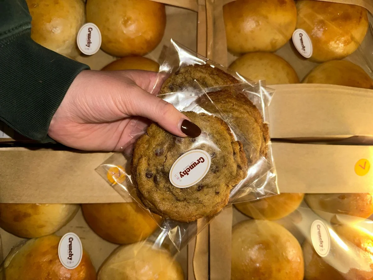 A chocolate chip cookie wrapped and ready to take home from Crunchy Loaf